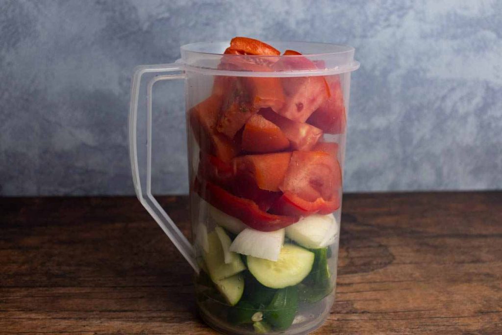 pitcher of cut up vegetables for gazpacho